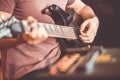 Close up hand of young man playing on a professional, black electric guitar, music instrument, entertainment, lifestyle Royalty Free Stock Photo