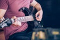 Close up hand of young man playing on a professional, black electric guitar, music instrument, entertainment, lifestyle Royalty Free Stock Photo