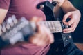 Close up hand of young man playing on a professional, black electric guitar, music instrument, entertainment, lifestyle Royalty Free Stock Photo