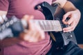 Close up hand of young man playing on a professional, black electric guitar, music instrument, entertainment, lifestyle Royalty Free Stock Photo