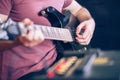 Close up hand of young man playing on a professional, black electric guitar, music instrument, entertainment, lifestyle Royalty Free Stock Photo