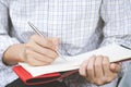 Close up hand young man are sitting using pen writing Record Lecture notepad Royalty Free Stock Photo