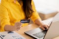 Close up hand of young woman using credit card for pay online shopping on computer laptop.Hand typing credit card number to buying Royalty Free Stock Photo