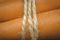 Close up of a handful of carrots tied with hemp rope