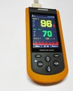 Close up handheld pulse oximeter medical devices use to monitor blood oxygen in patients in emergency room in hospital.