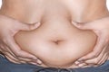 Close up handing front of woman belly fat overweight Royalty Free Stock Photo