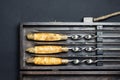 Close up handles Big luxury stainless steel skewers set in wooden box for grill and barbecue. Expensive high quality exclusive Royalty Free Stock Photo