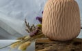 Close-up of Handmade Ceramic Vases and Dried flowers on wooden logs