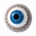 Close Up of a Handmade Knitted Eye Ball with Blue Pupil on White Backdrop Royalty Free Stock Photo