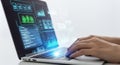 Hands typing on laptop displaying complex data charts and code on screen for analysis Royalty Free Stock Photo