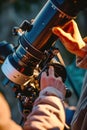 Close-up of hands adjusting telescope settings for observation