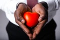 Close-up. Hands of an African American male doctor cardiologist with a red heart. Health care Royalty Free Stock Photo