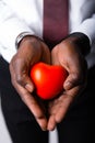 Close-up. Hands of an African American male doctor cardiologist with a red heart. Health care Royalty Free Stock Photo