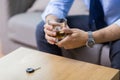 Close up of hands with alcohol and car key Royalty Free Stock Photo