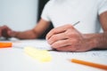 Close-up of hands architect uses laptop and building blueprint on working table in office space