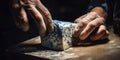Close up hands an artisan cheese maker prepares a small-batch, cave-aged blue cheese, concept of Food fermentation