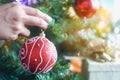 Close-up hands of asian women decorating green ball on christmas tree for prepare xmas party Royalty Free Stock Photo