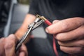 Close up of hands attaching a cable lug to a copper cable