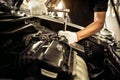 Close-up hands of auto mechanic are using the wrench to repair and maintenance auto engine