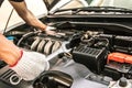 Close-up hands of auto mechanic are using the wrench to repair and maintenance auto engine i