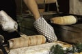 Male baker making typical Czech Trdelnik cake Royalty Free Stock Photo