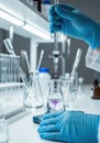 Scientist in blue gloves performs titration experiment in a bright laboratory setting Royalty Free Stock Photo