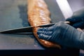 hand gloves cutting fish with knife Royalty Free Stock Photo