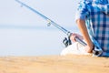 Close-up of hands of a boy with a fishing rod Royalty Free Stock Photo