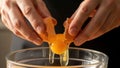 Close-up of hands breaking an egg into a glass mixing bowl. Royalty Free Stock Photo