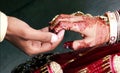 Close up of hands of bride and groom holding together at a traditional wedding. Royalty Free Stock Photo