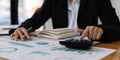 Close up hands of a business accountant woman using a calculator to analysis financial accounts check the company& x27;s Royalty Free Stock Photo