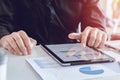 Close up hands business man in black shirt using tablet, point to discuss, plan and chart the rise and fall of the economy Royalty Free Stock Photo