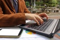 Close up hands of business man typing on laptop in park Royalty Free Stock Photo