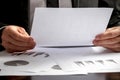 Close up of the hands of a businessman analysing a set of graphs Royalty Free Stock Photo