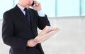 Close up of the hands of the businessman with a newspaper. Outdo Royalty Free Stock Photo