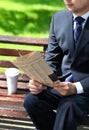 Close up of the hands of the businessman with a newspaper Royalty Free Stock Photo