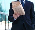 Close up of the hands of the businessman with a newspaper Royalty Free Stock Photo