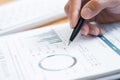 Close-up of hands Businessman reading and writing with pen signing contract over document for Completing Application Form at work