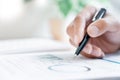 Close-up of hands Businessman reading and writing with pen signing contract over document for Completing Application Form at work Royalty Free Stock Photo