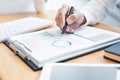 Close-up of hands Businessman reading and writing with pen signing contract over document for Completing Application Form at work Royalty Free Stock Photo