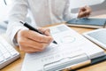 Close-up of hands Businessman reading and writing with pen signing contract over document for Completing Application Form at work Royalty Free Stock Photo