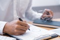 Close-up of hands Businessman reading and writing with pen signing contract over document for Completing Application Form at work Royalty Free Stock Photo