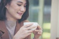 Close up Hands of businesswoman love drinking hot coffee. Woman hand holding black coffee cup in green garden cafe. business women Royalty Free Stock Photo