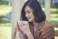 Close up Hands of businesswoman love drinking hot coffee. Woman hand holding black coffee cup in green garden cafe. business women Royalty Free Stock Photo