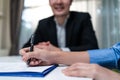 Close up hands of businesswoman sign contract agreement on paper with pen after negotiation for Business deal and acquisition. Inv Royalty Free Stock Photo