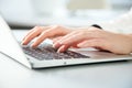 Close-up of hands of businesswoman typing on a laptop