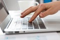 Close-up of hands of businesswoman typing on a laptop