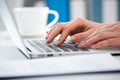 Close-up of hands of businesswoman typing on a laptop