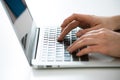 Close-up of hands of businesswoman typing on a laptop