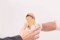 Hands of buyer, seller, ice-cream chocolate, coffee in waffle cone. Delicious cooling portion for fun. Real scene in